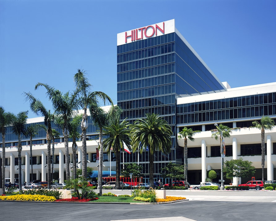 Exterior shot of a Hilton hotel entrance. 