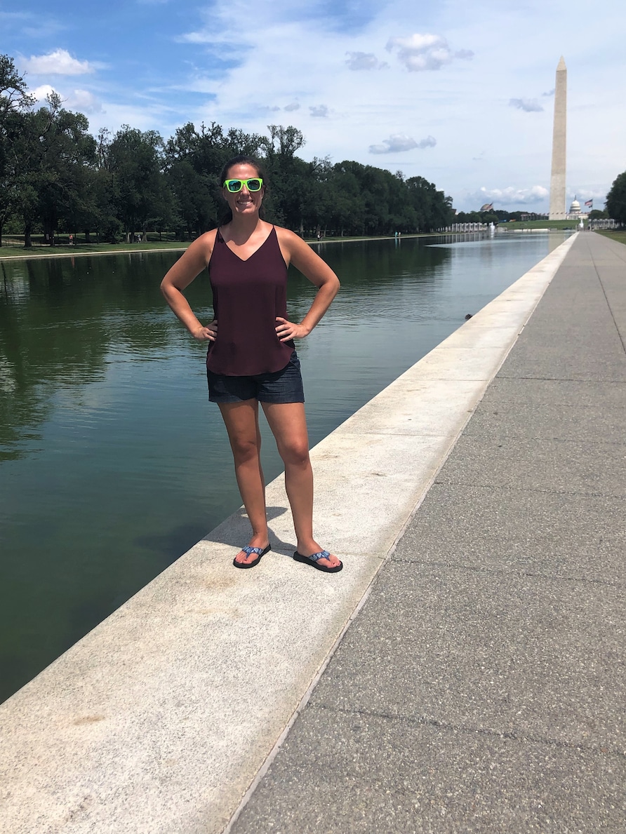 Hilton Grand Vacations Owner posing in front of the Washington Monument while on vacation in Washington, D.C.