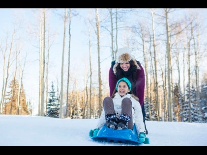 Mother and daughter playing in the snow in Park City, Utah.