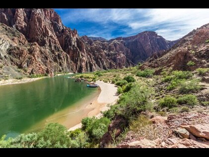 Aerial shot of a lake and raft in Grand Canyon National Park in Arizona.