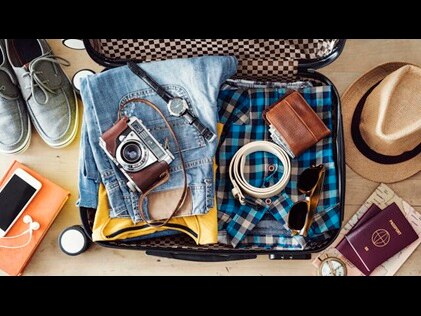 Overhead shot of a man's suitcase preparing to travel. 