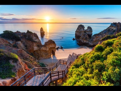 Picturesque wooden boardwalk leading to the beach in Portugal. 