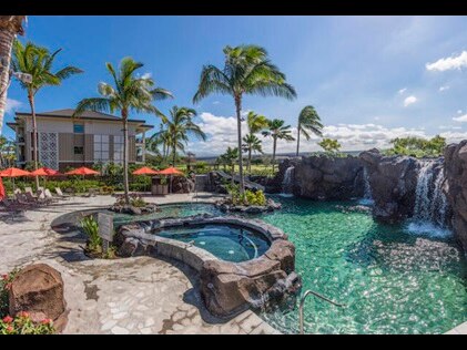 Stunning poolside views showcasing pool waterfall at Kings' Land by Hilton Grand Vacations. 