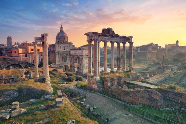 Acient architecture with cotton candy skies overhead, Rome, Italy. 