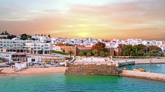 Gorgeous aerial image, coastal city against sunset skies, the Algarve, Lagos, Portugal. 