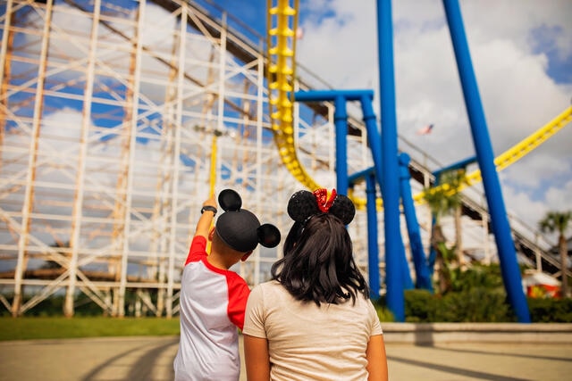 Woman and young child admiring roller coaster at Orlando theme Park, Florida. 