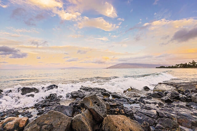 Ocean washing ashore against lava rocks, Maui, Hawaii. 