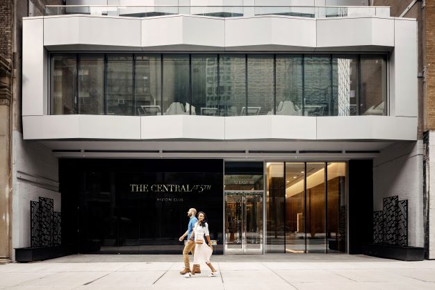 Couple holding hands, walking, The Central at 5th, a Hilton Club, New York, New York. 