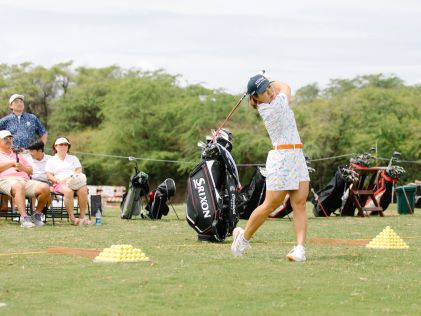 LPGA player Nasa Hataoka demonstrating her swing at an HGV Presents event