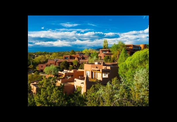 Iconic pueblo-style architecture set against the bright blue sky, Santa Fe, New Mexico.