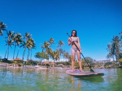 A Hilton Grand Vacations Member surfs in the lagoon at Hilton Waikoloa Village on the Big Island of Hawaii